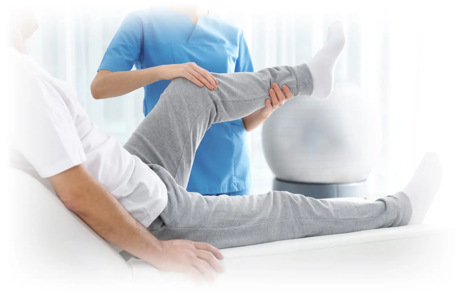 Physiotherapist treating a patient's leg at Axios Physio clinic in Swords, Dublin