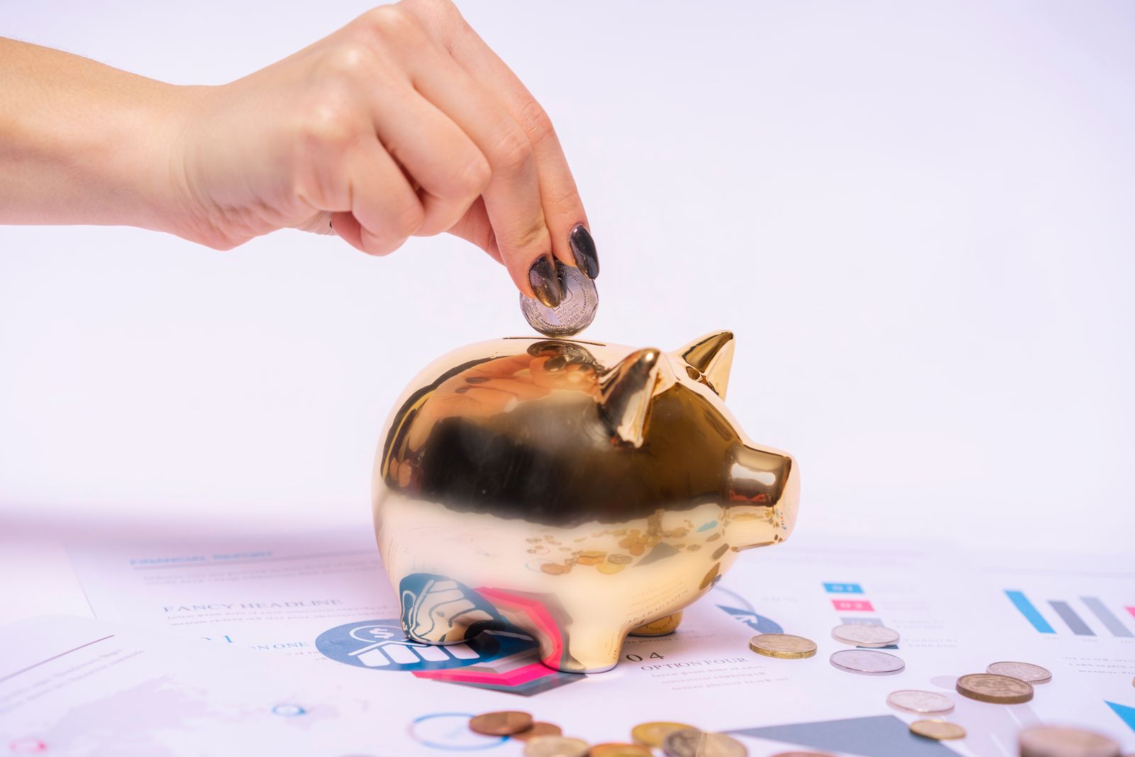 Hand placing a coin into a piggy bank on financial documents, representing tax relief savings on physiotherapy in Ireland